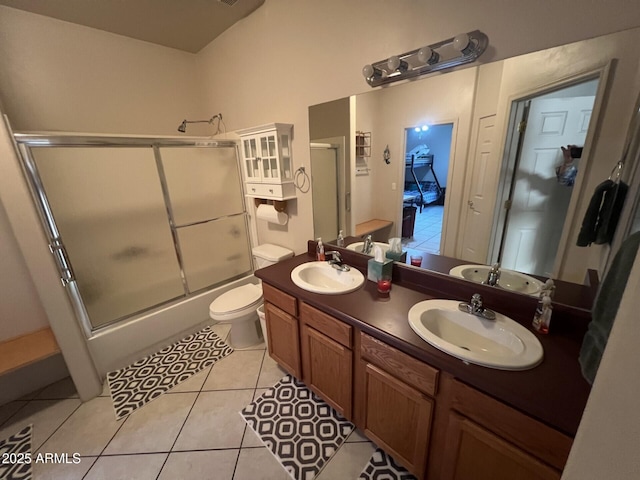 full bathroom featuring tile patterned flooring, vanity, combined bath / shower with glass door, and toilet