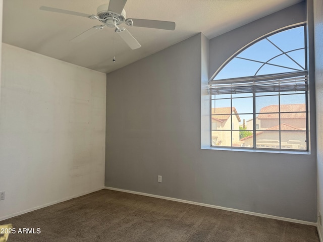 empty room with baseboards, ceiling fan, and carpet
