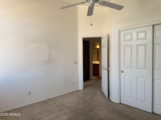unfurnished bedroom featuring a closet, ceiling fan, carpet floors, and baseboards
