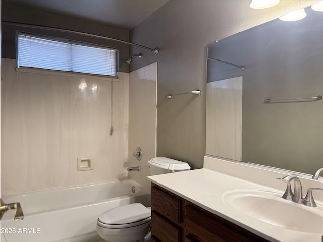 bathroom featuring toilet, vanity, and  shower combination