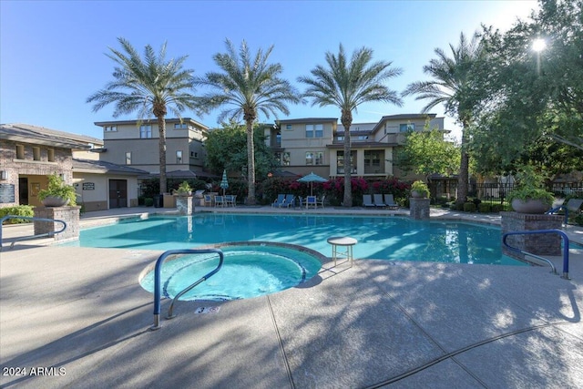 view of pool featuring a community hot tub and a patio