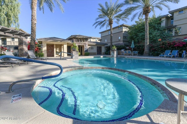 view of pool featuring a community hot tub and a patio