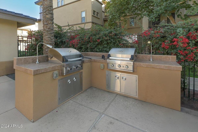 view of patio with an outdoor kitchen and area for grilling