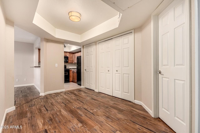 1331 W Baseline Rd Unit 167, Mesa, AZ 85202 - unfurnished bedroom featuring a tray ceiling, dark wood-type flooring, and freestanding refrigerator