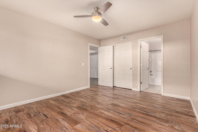 1331 W Baseline Rd Unit 167, Mesa, AZ 85202 - unfurnished bedroom featuring wood finished floors, ensuite bath, a closet, and ceiling fan