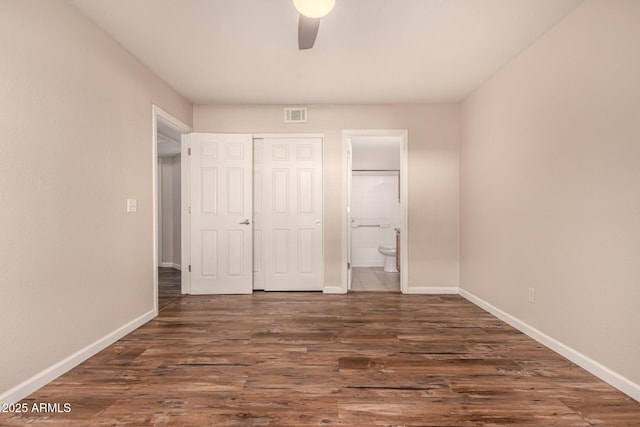 1331 W Baseline Rd Unit 167, Mesa, AZ 85202 - unfurnished bedroom with connected bathroom, dark wood finished floors, a closet, and a ceiling fan