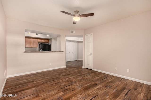 1331 W Baseline Rd Unit 167, Mesa, AZ 85202 - unfurnished living room featuring a ceiling fan and dark wood-style floors