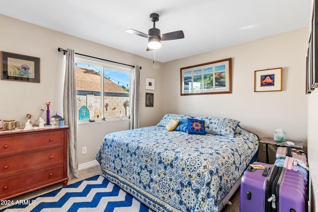 bedroom featuring ceiling fan and light carpet