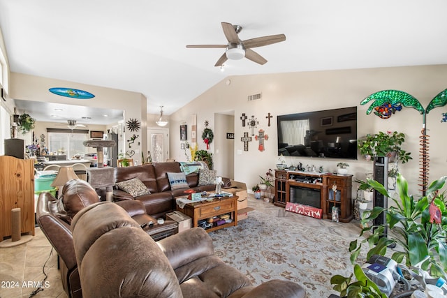 tiled living room featuring ceiling fan and lofted ceiling