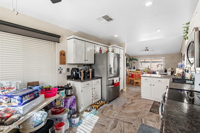 kitchen with lofted ceiling, kitchen peninsula, ceiling fan, white cabinetry, and stainless steel fridge with ice dispenser