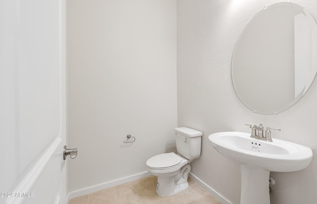 bathroom with toilet and tile patterned flooring