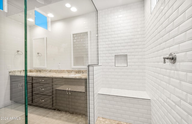 bathroom featuring vanity, tile patterned floors, and a shower with shower door