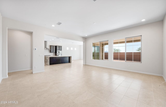 unfurnished living room with light tile patterned floors