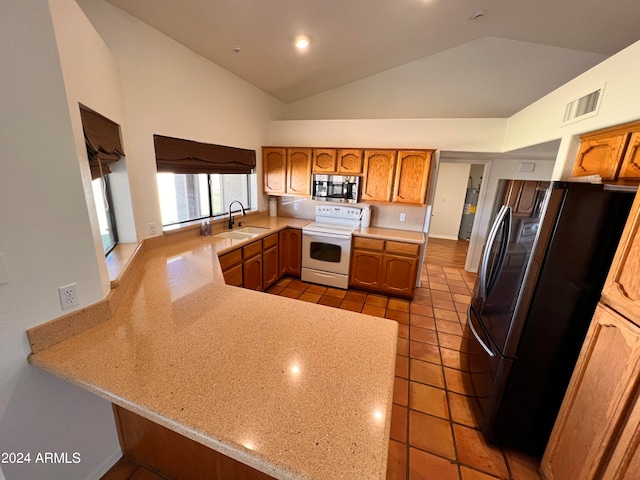 kitchen featuring sink, kitchen peninsula, stainless steel appliances, high vaulted ceiling, and decorative backsplash