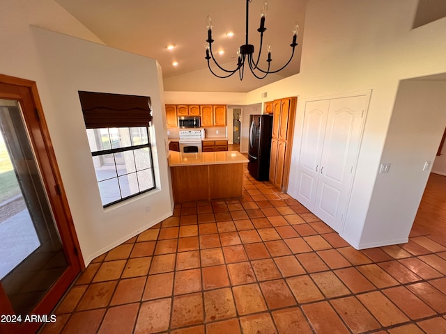 kitchen featuring black fridge, kitchen peninsula, light tile patterned floors, white stove, and high vaulted ceiling