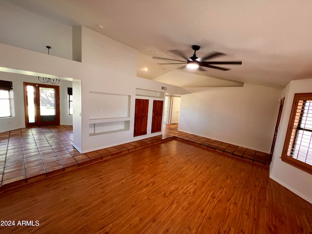 unfurnished living room featuring ceiling fan, vaulted ceiling, and hardwood / wood-style floors