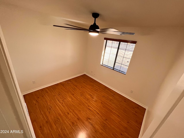 empty room with ceiling fan and hardwood / wood-style flooring