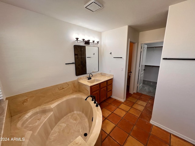 bathroom featuring vanity, a tub to relax in, and tile patterned flooring