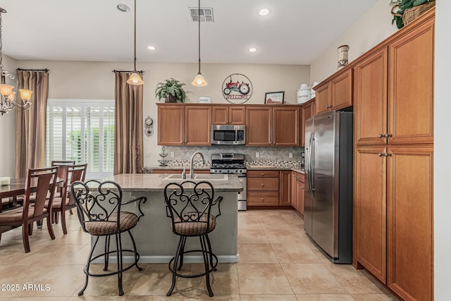 16747 W Berkeley Rd, Goodyear, AZ 85395 - kitchen with appliances with stainless steel finishes, light stone countertops, a sink, backsplash, and light tile patterned floors