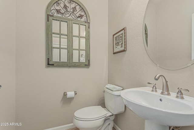 16747 W Berkeley Rd, Goodyear, AZ 85395 - half bath with a sink, toilet, and baseboards