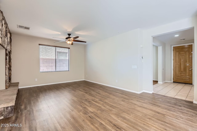 1710 S Parkcrest St, Gilbert, AZ 85295 - unfurnished living room featuring a ceiling fan, wood finished floors, and baseboards