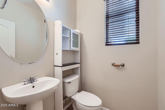 1710 S Parkcrest St, Gilbert, AZ 85295 - half bathroom featuring a sink, toilet, and baseboards