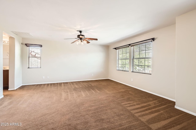 1710 S Parkcrest St, Gilbert, AZ 85295 - spare room with dark colored carpet, baseboards, and a ceiling fan