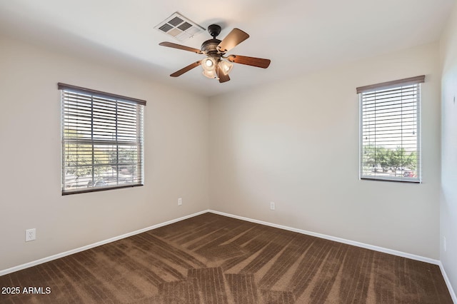 1710 S Parkcrest St, Gilbert, AZ 85295 - spare room with plenty of natural light, ceiling fan, dark carpet, and baseboards