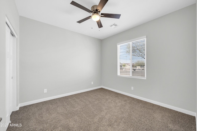 unfurnished bedroom with baseboards, visible vents, and dark colored carpet