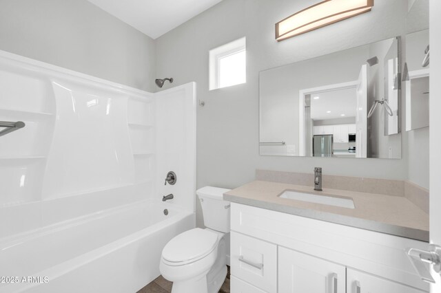 bathroom with toilet, shower / washtub combination, and vanity