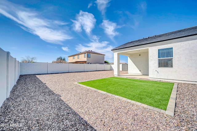 view of yard with a patio area and a fenced backyard