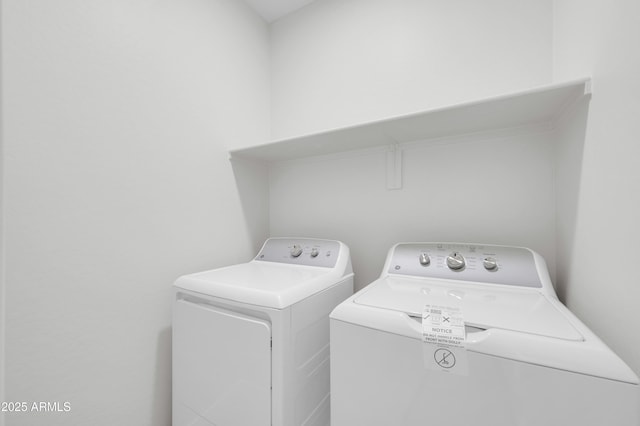 washroom with washing machine and clothes dryer and laundry area