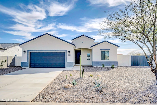 view of front of house featuring fence, driveway, an attached garage, stucco siding, and a tile roof