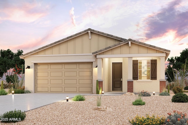 view of front of property featuring an attached garage, board and batten siding, concrete driveway, and brick siding