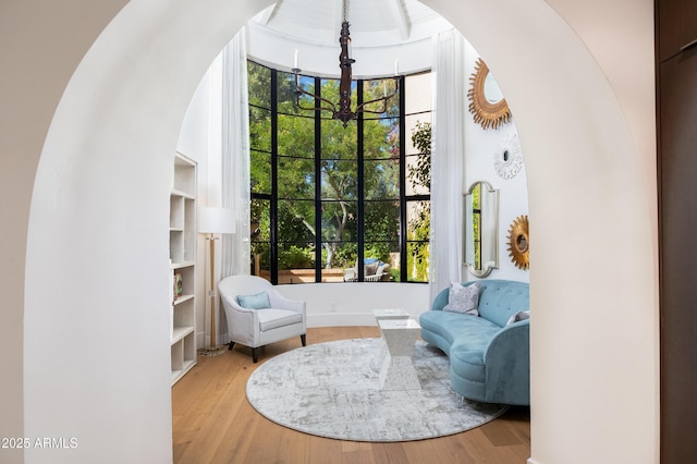 sitting room with an inviting chandelier and light hardwood / wood-style floors