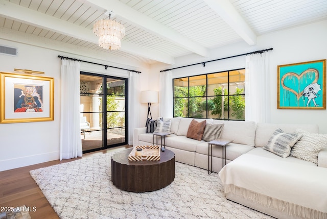 living room with wood-type flooring, a chandelier, and beam ceiling