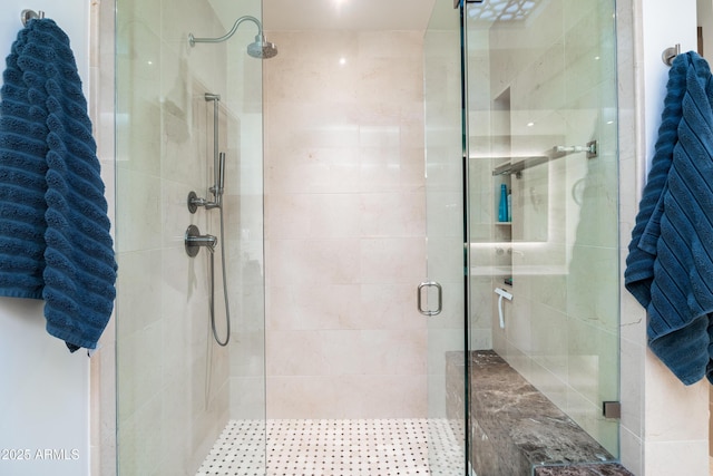 bathroom with a shower with door