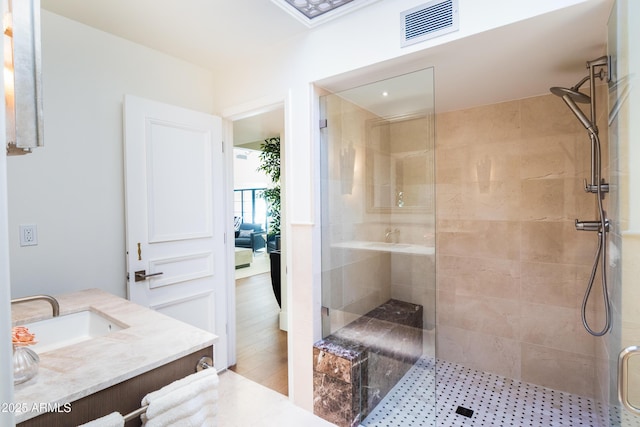 bathroom with vanity, wood-type flooring, and walk in shower