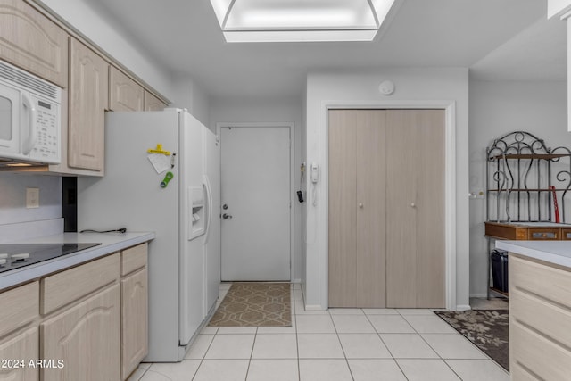 kitchen with white appliances, light tile patterned flooring, and light brown cabinets