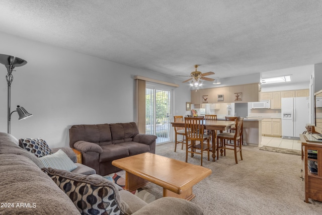 carpeted living room with ceiling fan and a textured ceiling