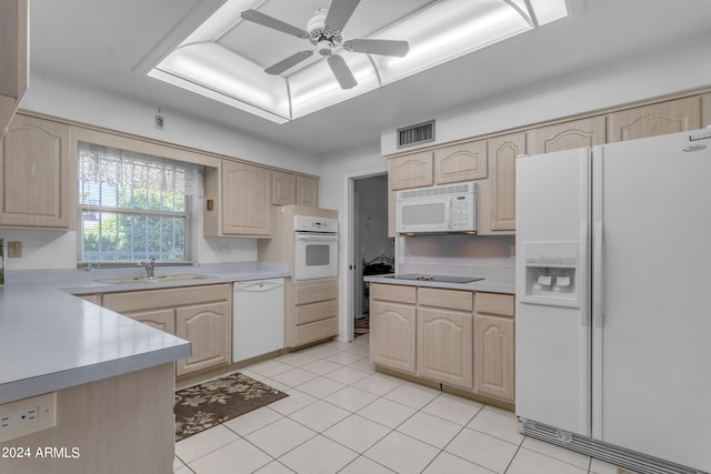 kitchen with sink, white appliances, light tile patterned floors, ceiling fan, and light brown cabinets