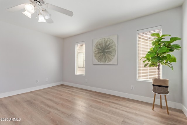 unfurnished room featuring ceiling fan, baseboards, light wood-type flooring, and plenty of natural light