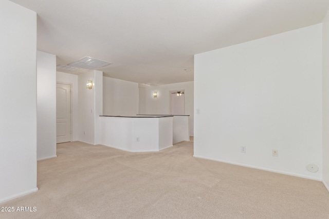 empty room with light colored carpet and baseboards