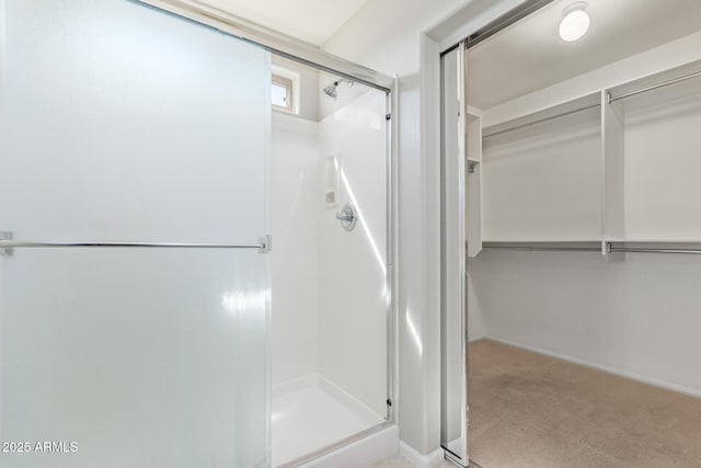 full bath with baseboards and a stall shower