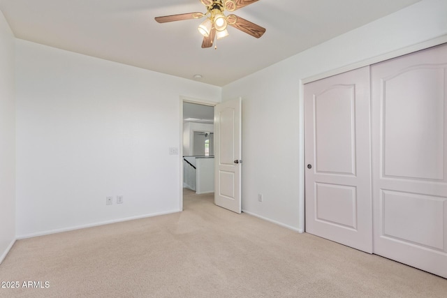 unfurnished bedroom featuring baseboards, carpet floors, and a closet