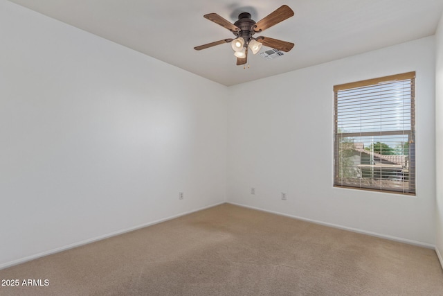 unfurnished room with light colored carpet, ceiling fan, baseboards, and visible vents