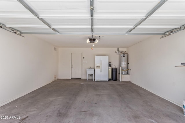 garage with water heater, a garage door opener, white fridge with ice dispenser, and a sink