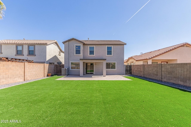 back of house featuring stucco siding, a patio, and a fenced backyard