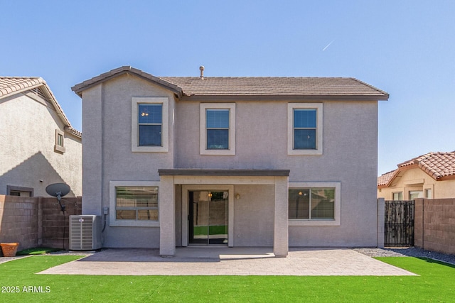 rear view of property with fence, cooling unit, stucco siding, a patio area, and a tile roof