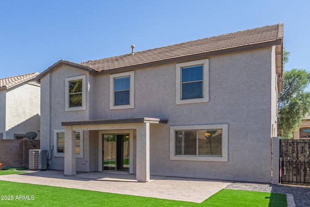 back of property featuring stucco siding, central AC unit, and a patio area